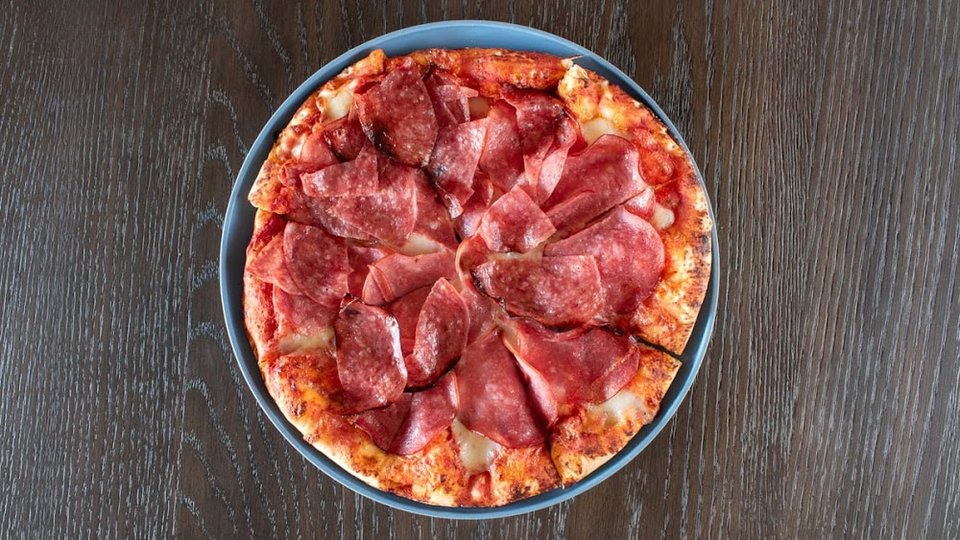 Pizza menu with specialty pies listed.